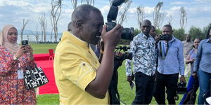 President William Ruto taking a photo during a government retreat on February 21, 2024.