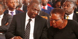 A photo of President William Ruto (left) conversing with Water Cabinet Secretary Alice Wahome.