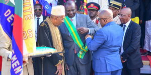 President William Ruto receiving the Grand Cross of the Green Crescent of Comoros award from the President of Comoros on July 6, 2023.