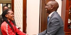 President William Ruto holding hands with athlete Faith Kipyegon at State House Nairobi on Tuesday June 13, 2023