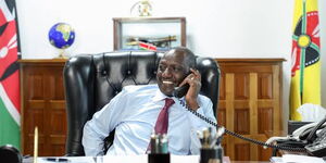A photo of President William Ruto making a phone call to a maize farmer in Kuria, Migori county on November 9, 2023. 