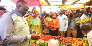 President William Ruto (far left) interacts with Mama Mbogas during campaigns on October 14, 2021.