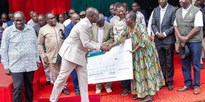 President William Ruto issuing cheques to Nzoia Sugar Company farmers on Thursday, February 1, 2024. 