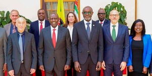 President William Ruto (red tie) poses for a photo alongside officials from Bridgin Foundation at State House on March 21, 2023.