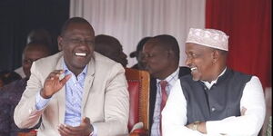 President William Ruto (left) and former Defence CS Aden Duale share a moment of laughter during a ceremony on December 21, 2023. 