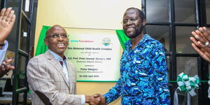 Safaricom CEO Peter Ndegwa (left) shaking hands with Kisumu Governor Anyang' Nyong'o ceremonially reveals the recently inaugurated Mother and Child Centre at Ratta Health Center, located in Seme Sub County, Kisumu County on April 12, 2024