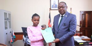 An image of Petronilla Mutono (left) and Nairobi Deputy Governor Njoroge Muchiri (right) during the presentation of the executive scholarship