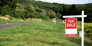 Signage indicating that the parcel of land is for sale. 