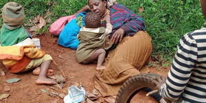 Sarah and her children pictured outside her mud-house in Karima-Othaya, Nyeri County.
