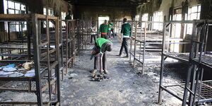 A student scavenges through the remnants of a past fire accident 