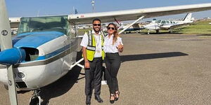 BBC journalist Anisha Shah (right) posing for a photo with another pilot at an airfield.