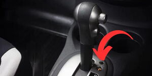 An image showcasing where the shift lock button is located in an automatic car