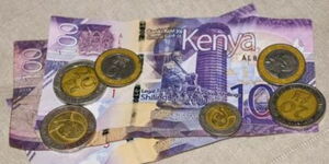 A hundred Kenyan shilling banknotes and ten shilling coins