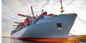 A photo of a freight ship on sea ferrying containers on board