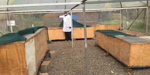 Dr Paul Kinoti in a snail farm.