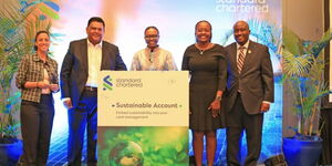 Executives pose for a photo during the Standard Chartered launch for the sustainability account
