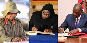A photo of East African Presidents: From left President Yoweri Museveni, Samia Suluhu Hassan and William Ruto signing documents