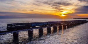A train crossing a bridge built across a sea 