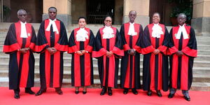 Supreme Court of Kenya judges pose for a photo outside the Supreme Cout building in Nairobi.