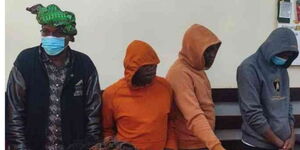 A photo of suspects who sold exhibit alcohol covered up during their arraignment in court