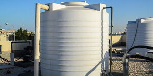 Water tanks installed on top of a flat roof apartment
