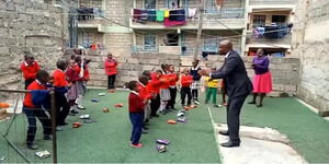 A screengrab of a video in which Mathias Momanyi is dancing with children