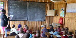 A photo of a Kenyan schoolteacher in classroom.