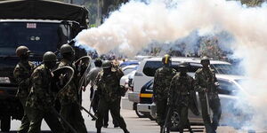 Police firing teargas at protestors.