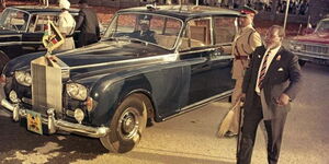 The late President Mzee Jomo Kenyatta (in suit) next to his Rolls Royce in 1963
