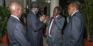 President William Ruto and his predecessor Uhuru Kenyatta onlooking former Prime Minister Raila Odinga conversing with President Salva Kiir of South Sudan on July 1, 2019.