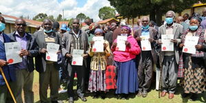 Uasin Gishu residents holding their title deeds issued by the Ministry of Lands on July 7, 2022