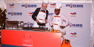 TotalEnergies Marketing Kenya Managing Director Eric Fanchini (left) and M-Gas Chief Executive Officer Martin Kimani in a cooking demonstration during the launch of their co-branded LPG cylinder. The metered cylinder is designed to deepen access to innovative Pay-as-you-Cook clean cooking solutions to low-income households in Kenya.
