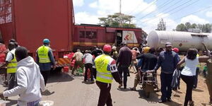 A section of youth loot after a Nanyuki-bound train rams into a soda truck in Karatina town on Wednesday, September 22.