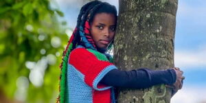 Truphena Muthoni hugging a tree in her attempt to break the Guinness World Record on December 8, 2025