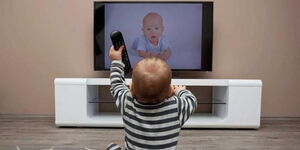 A photo of a child watching TV 