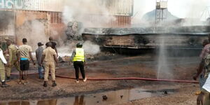Fire fighters putting off fire after fuel tanker burst in flames at Malaba border on Tuesday, December 13, 2022