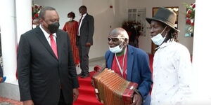 President Uhuru Kenyatta and benga musician Paul Mutonga alias Wanganangu sing songs during the 2021 Mashujaa Day luncheon.