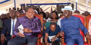 Former President Uhuru Kenyatta and opposition leader Raila Odinga at the burial of ex-Education CS Prof. George Magoha in Gem, Siaya County, on February 11, 2023.