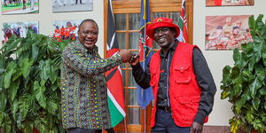 President Uhuru Kenyatta and Kiambaa MP aspirant Kariri Njama during a meeting at State House on Thursday, July 8.