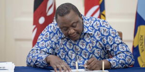 President Uhuru Kenyatta assenting to bills at State House on March 30, 2021.