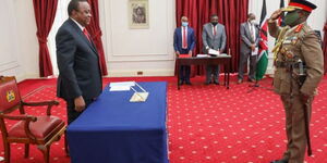 President Uhuru Kenyatta (left) during the swearing-in of General Robert Kariuki Kibochi as the new Chief of the Kenya Defence Forces (CDF) at State House Nairobi on May 11, 2020.