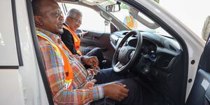 Former President Uhuru Kenyatta behind the wheel of a Toyota Hilux