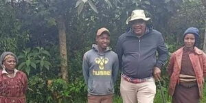 President Uhuru Kenyatta (center) takes a photo with Eunice Wanjiku (far left) and her daughter Esther Nyambura (right) at a village in Gakoe, Kiambu County.