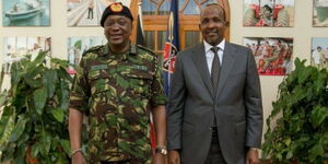 A photo of Defence CS Aden Duale (right) and former President Uhuru Kenyatta (left). 