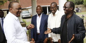 Governor Lonyangapuo (in black Jacket) shares a light moment with President Uhuru Kenyatta in 2019.
