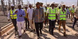 President William Ruto and his predecessor, Uhuru Kenyatta, touring the Lake Turkana Wind Power project in July 2019.