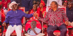 Former Prime Minister Raila Odinga and Former President Uhuru Kenyatta holding hands at the Jubilee Party NDC on May 22, 2023. President William Ruto speaking in Isiolo on May 21 (in a circle). 