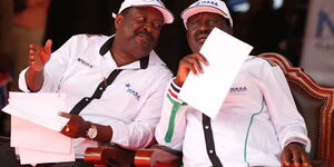 Amani National Congress (ANC) leader consults with Orange Democratic Movement (ODM) leader Raila Odinga during a rally at Uhuru Park on April 2, 2017.
