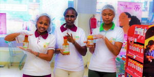 Viola Maina, founder of Gooseberry Delight (centre), and two of her employees display some of the company’s products.