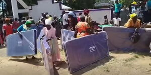 Voters receiving mattresses branded GOK on election day in Malava constituency during the recently concluded November 27, 2025, by-election